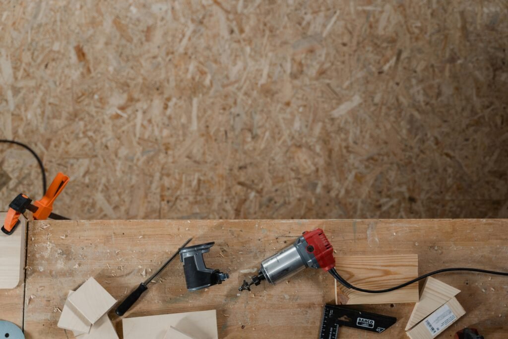 Aerial shot of carpentry tools on a wooden workbench, ready for woodwork.